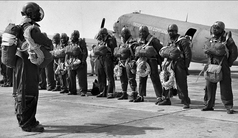 Members of the 555th Parachute Infantry Battalion at Pendleton Army Airfield getting briefed before taking off to drop on a wildfire in the summer of 1945. (National Archives via Eastern Washington University)