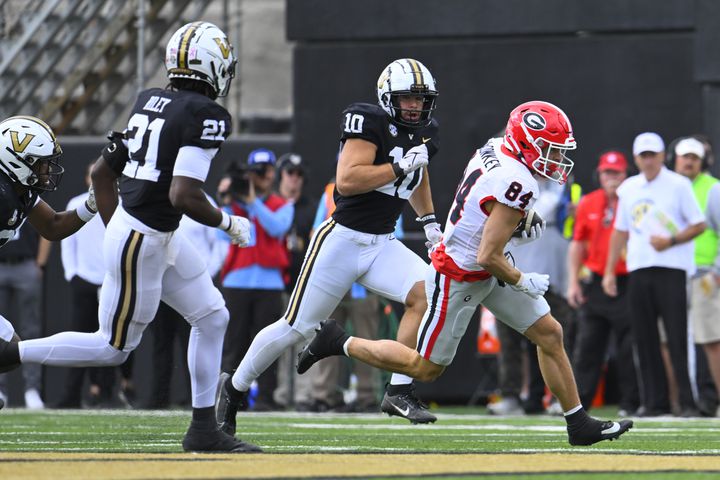 Georgia wide receiver Ladd McConkey (84) runs against Vanderbilt safety Savion Riley (21) and linebacker Langston Patterson (10) during the first half of an NCAA football game, Saturday, Oct. 14, 2023, in Nashville, Tenn. (Special to the AJC/John Amis)