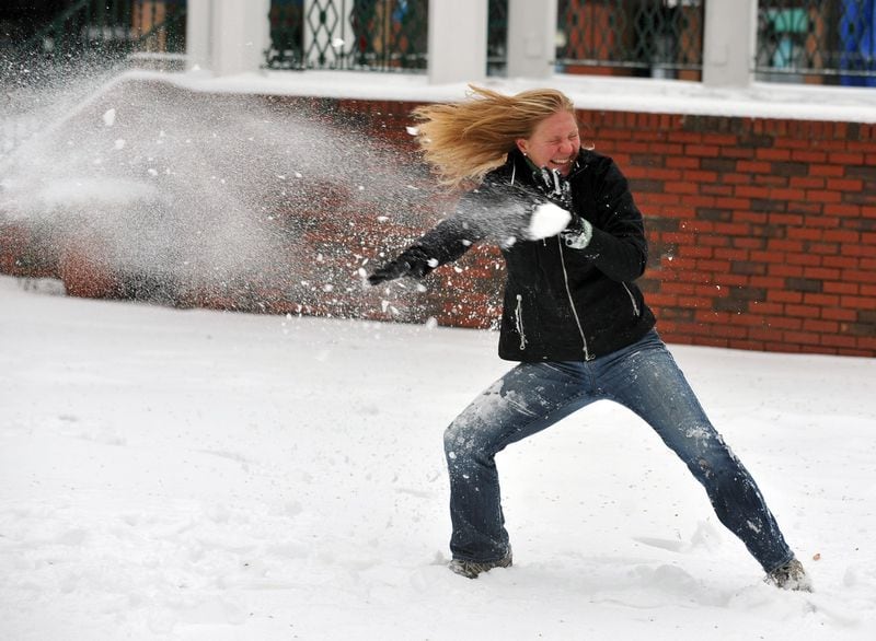 Elisabeth Lewis is hit with a snowball from her boyfriend, Chris Dawson, in Austell on January 11, 2011. (Brant Sanderlin / AJC)