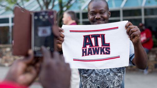 Christopher Robinson poses for a photo with an Atlanta Hawks towel before the first game of the NBA Eastern Conference finals between the Atlanta Hawks and the Cleveland Cavaliers, Wednesday, May 20, 2015, in Atlanta. BRANDEN CAMP/SPECIAL