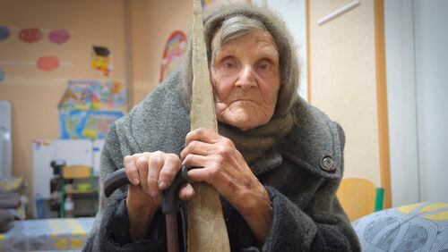 In this photo provided by the Ukrainian National Police of Donetsk region, 98-year-old Lidia Lomikovska sits in a shelter after she escaped Russian-occupied territory in the Donetsk region, Ukraine, April 26, 2024. Lomikovska left the frontline town of Ocheretyne last week by walking almost 10 km (6 miles) alone, after Russian troops entered it and fighting intensified. (Ukrainian National Police of Donetsk region via AP)
