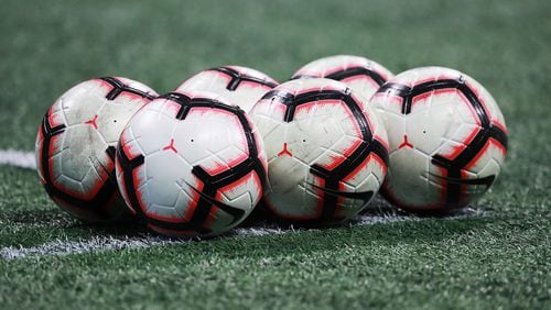 MLS soccer balls sit on the field for Atlanta United and Monterrey in thier CONCACAF Champions League quarterfinal match Wednesday, March 13, 2019, in Atlanta.