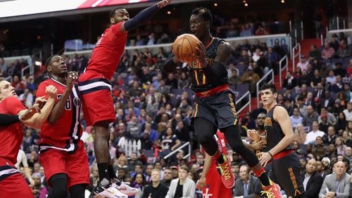 Dennis Schroder of the Atlanta Hawks looks to pass around John Wall of the Washington Wizards at Verizon Center on March 22, 2017 in Washington, D.C. (Photo by Rob Carr/Getty Images)