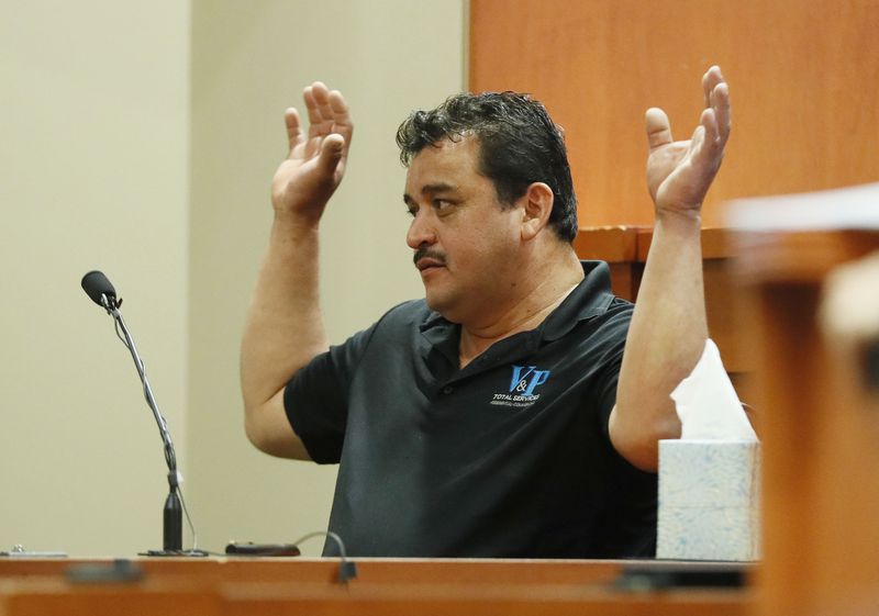 September 27, 2019 - Decatur -  Pedro Castillo Flores shows how Anthony Hill had his hands raised before the shooting.  The murder trial of former DeKalb County Police Officer Robert "Chip" Olsen continued with testimony from prosecution witnesses this morning.  Olsen is charged with murdering war veteran Anthony Hill.  Bob Andres / robert.andres@ajc.com