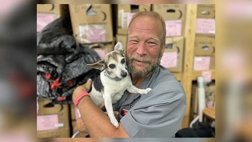 Don Bickford and his adopted dog, Maggie, pose at the East Ridge Church of Christ Benevolent Center in Chattanooga. (Photo Courtesy of Mark Kennedy)