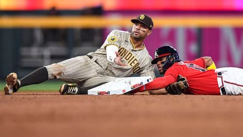 Padres shortstop Xander Bogaerts (2) gestures after attempting to tag Braves right fielder Ronald Acuna Jr. (13) out at second base in the fifth inning Friday, April 7, 2023 at Truist Park in Atlanta. (Daniel Varnado / For the AJC)