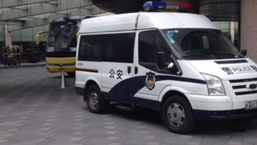 Police vehicle sits outside Georgia Tech team hotel as 3 players were investigated over several hours on Tuesday in Hangzhou, China. (AJC photo by Ken Sugiura)