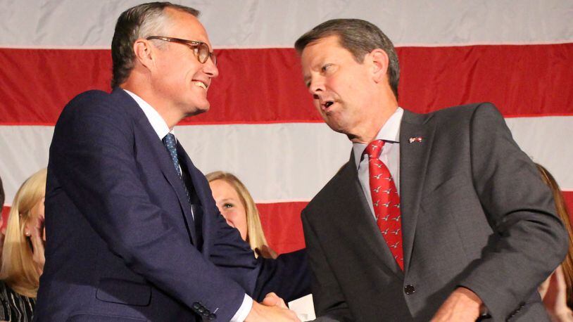 Lt. Gov. Casey Cagle shakes hands with Republican nominee for Georgia Governor Brian Kemp, left to right, after Kemp won the runoff for governor at Hilton Atlanta Northeast on Thursday, July 26 at a Republican Unity Rally. Jenna Eason / Jenna.Eason@coxinc.com