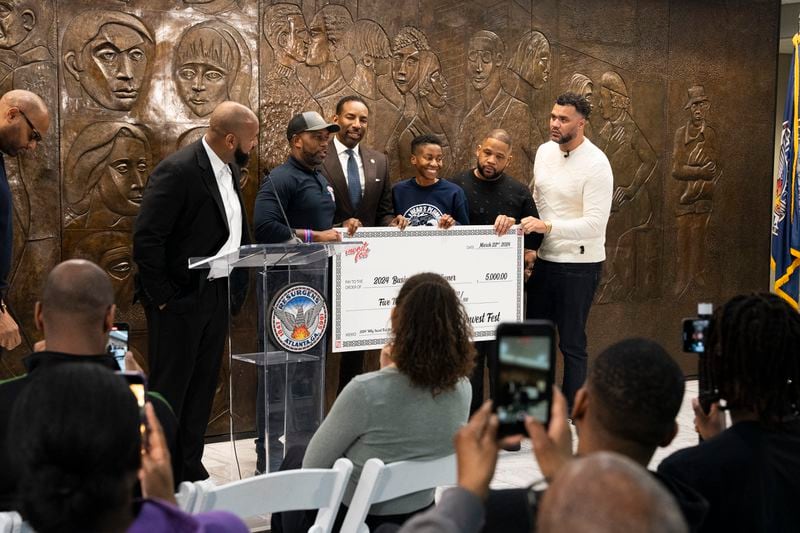 Head's Plumbing accepts an award at a special announcement revealing details for the fourth annual Invest Fest, at Atlanta City Hall on Friday, March 22, 2024. (Olivia Bowdoin for the AJC). 