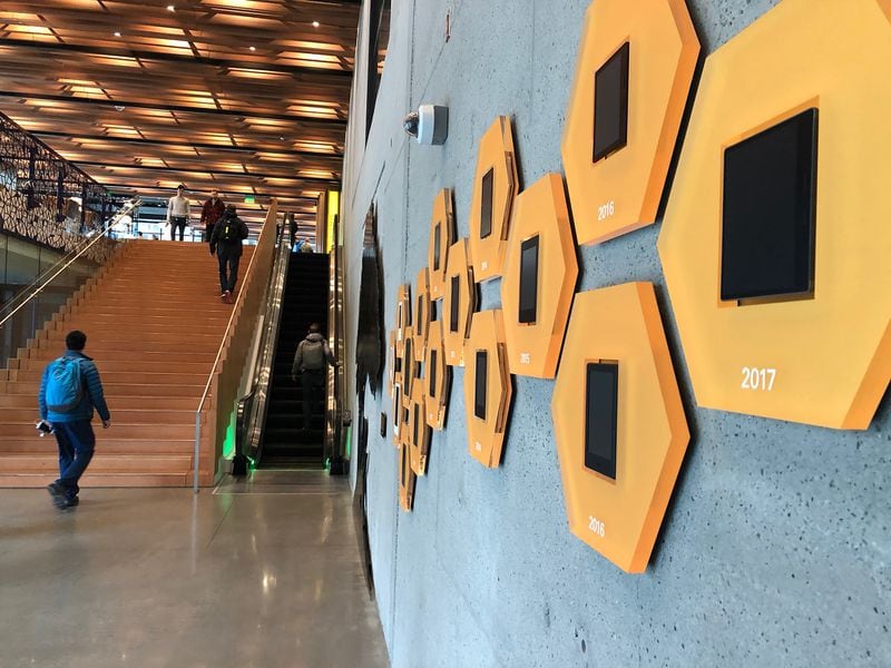 A display of Amazon Kindle e-readers line the wall in the lobby of an Amazon headquarters office in Seattle in April 2017. (Scott Trubey / Scott.Trubey@ajc.com)