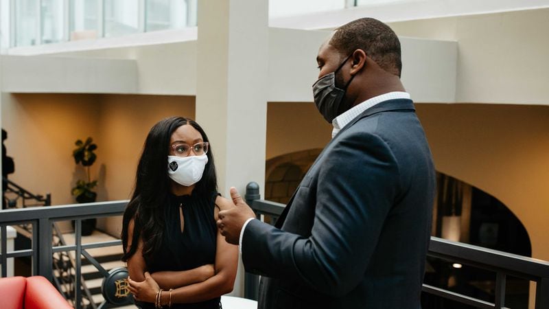 Spelman College student Kayla Norman, left, speaks with Parris Boyd, right, a Clark Atlanta University graduate who is partner with the Firmament Group, a private equity fund, at a University Growth Fund event in downtown Atlanta on Aug. 25, 2021. (UNIVERSITY GROWTH FUND)