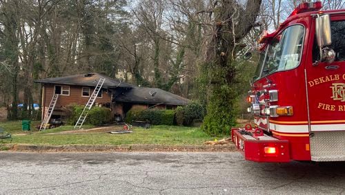 A woman is in critical condition after being pulled from a burning DeKalb County home Friday morning, officials said.