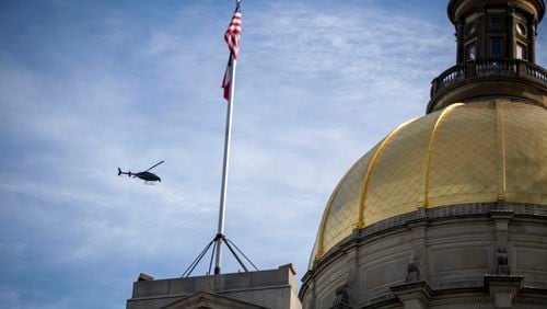 01/06/2021 — Atlanta, Georgia — A helicopter circles the Georgia State Capitol building during a ‘Stop the Steal’ rally outside of the Georgia State capital building in downtown Atlanta, Wednesday, January 6, 2021. (Alyssa Pointer / Alyssa.Pointer@ajc.com)