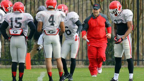 032514 ATHENS: Georgia new defensive coordinator Jeremy Pruitt is on the run keeping his defensive players moving through drills during team practice on Tuesday, March 25, 2014, in Athens. CURTIS COMPTON / CCOMPTON@AJC.COM Jeremy Pruitt has been given free rein to fix Georgia's defense. (Curtis Compton, AJC)