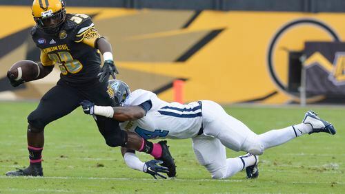 Kennesaw State running back Darnell Holland (33) is hit by Point cornerback Kalen Newsome (4 ) during the first half of an NCAA college football game, Saturday, Oct. 10, 2015, in Kennesaw, Ga. (AP Photo/Lisa Marie Pane)