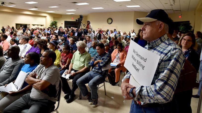 Ernie Duke was one of the hundreds of DeKalb County residents who filled the Maloof Auditorium to a standing room only capacity Thursday night, seeking answers to high water bills. BRANT SANDERLIN/BSANDERLIN@AJC.COM