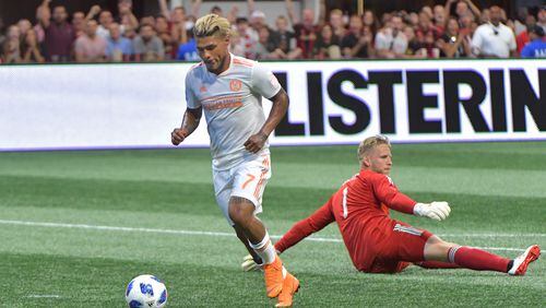 Atlanta United forward Josef Martinez (7) gets past D.C. United goalkeeper David Ousted (1) to shoot for his 6th career MLS hat trick during the second half in a MLS soccer game at Mercedes-Benz Stadium on Saturday, July 21, 2018. Three more goals from Josef Martinez set a new MLS record lifted Atlanta United to a 3-1 victory over D.C. United on Saturday at Mercedes-Benz Stadium. HYOSUB SHIN / HSHIN@AJC.COM