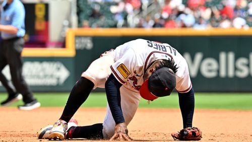 Braves second baseman Ozzie Albies rises after trying to catch a ball on August 2, 2023, in Atlanta. (Hyosub Shin / Hyosub.Shin@ajc.com)