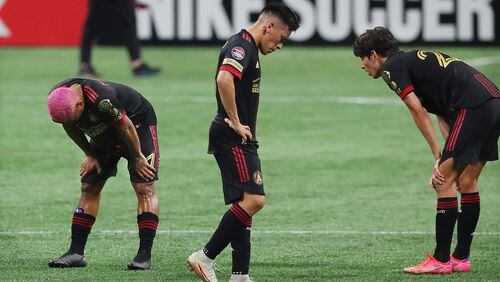 Atlanta United players Josef Martinez (from left), Ezequiel Barco and Jurgen Damm react as time expires to falling 3-0 to the Philadelphia Union in the first leg of the CONCACAF Champions League quarterfinals Tuesday, April 27, 2021, at Mercedes-Benz Stadium in Atlanta. (Curtis Compton / Curtis.Compton@ajc.com)