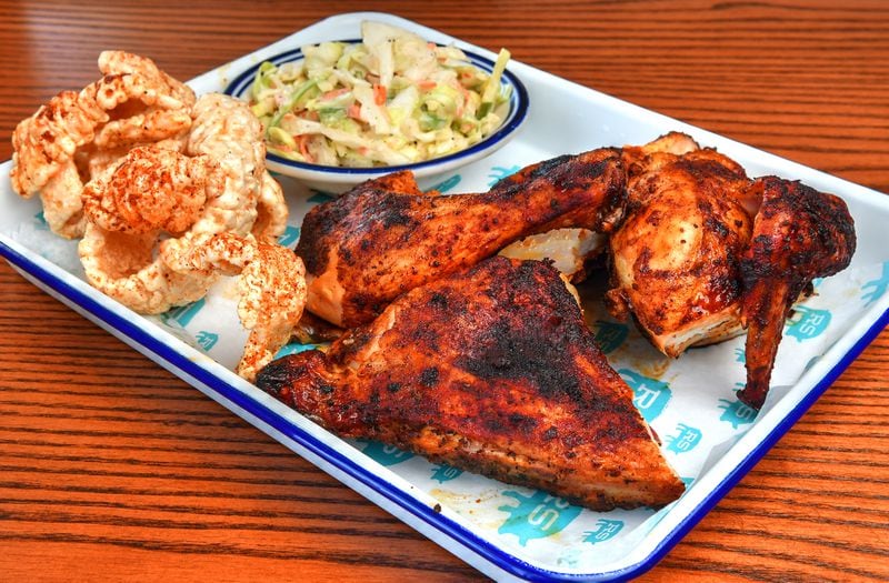 Rodney Scott's Whole Hog BBQ menu includes a 1/2 Bird Chicken plate. Here it's shown with coleslaw and pork skins. The skins are definitely worth seeking out. (Chris Hunt for The Atlanta Journal-Constitution)