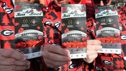 Georgia fans show off their tickets arriving for the College Football Playoff Semifinal at the Rose Bowl Game on Monday, January 1, 2018, in Pasadena. Curtis Compton/ccompton@ajc.com