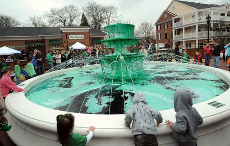 A crowd of children ogle Smyrna's Market Village fountain dyed green for the annual Smyrna St. Patrick’s Day Festival in 2010.