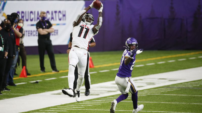 Atlanta Falcons wide receiver Julio Jones (11) goes high to catch a pass over Minnesota Vikings cornerback Cameron Dantzler during the second half Sunday, Oct. 18, 2020, in Minneapolis. (Bruce Kluckhohn/AP)