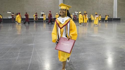 Marisela Lozada smiles as she walks to meet her family after graduating from Maynard Jackson High School at the Georgia World Congress Center on May 22, 2018. The center is not available for 2019 high school graduation ceremonies, causing school districts to have to search for other big venues. ALYSSA POINTER/ATLANTA JOURNAL-CONSTITUTION