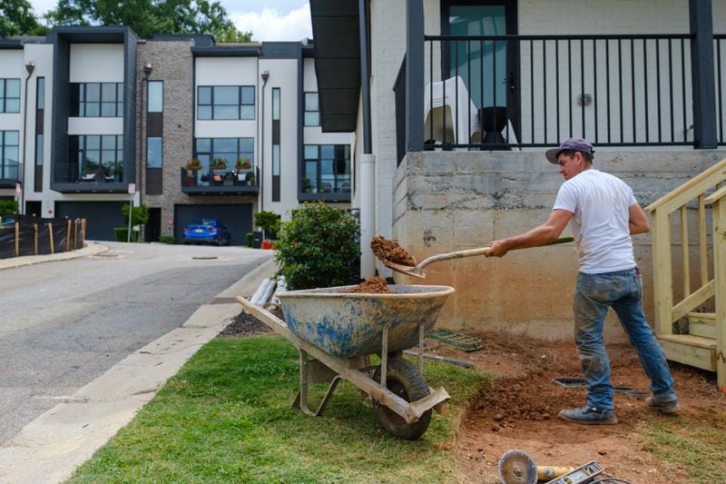 A construction worker works at a townhouse complex in Decatur on Monday, July 25, 2022. The projected high is 90 degrees. (Arvin Temkar / arvin.temkar@ajc.com)