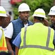Mayor Andre Dickens (center) and Al Wiggins, Jr., (right) Commissioner of Department of Watershed Management, confer with staff about a water main rupture in Atlanta.