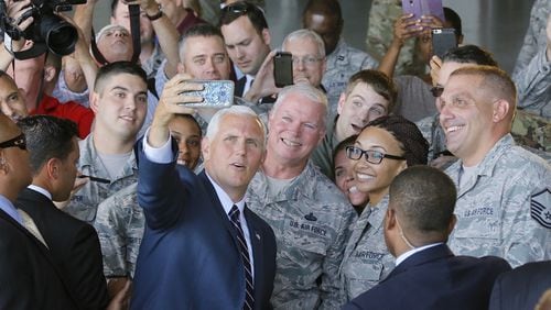 Vice President Mike Pence take a selfie using the phone of Senior Airman Lauren Douglas with the military crowd at Dobbins Air Reserve Base in Marietta on Friday, June 9, 2017.