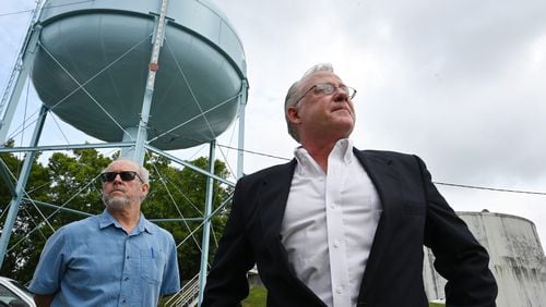 Mike Hackett (right), the director of the city of Rome’s water and sewer division, and Frank Beacham, attorney for the city of Rome, stand outside the City of Rome’s Bruce Hamler Water Treatment Facility in Rome on Tuesday, August 23, 2022. (Hyosub Shin / Hyosub.Shin@ajc.com)