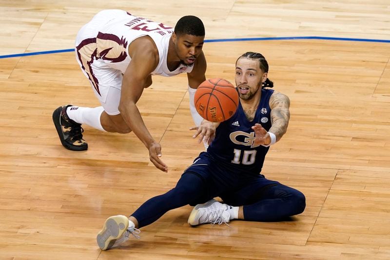 Georgia Tech guard Jose Alvarado (10) passes the ball as Florida State guard M.J. Walker (23) defends during the first half of Saturday's ACC championship game.