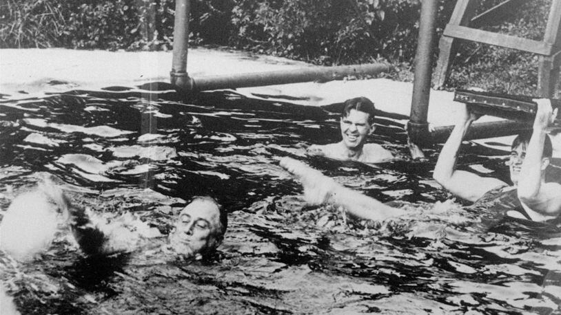 President Franklin D. Roosevelt, lower left, is shown swimming in the pool of the Polio Foundation in Warm Springs in March 1935. Roosevelt in 1927 established a polio treatment facility there that became the Roosevelt Warm Springs Rehabilitation Hospital. (AP Photo/FILE)