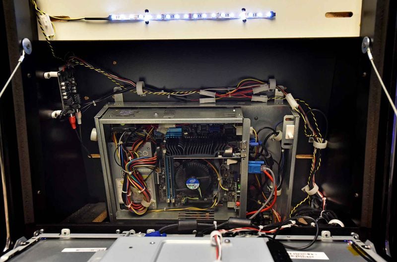 An inside look of a coin-operated amusement machine in Georgia Lottery’s test lab. Wiring inside the machine connects to a central accounting system so revenue can be accurately tracked. Last year, the games contributed $47.5 million toward education. HYOSUB SHIN / HSHIN@AJC.COM