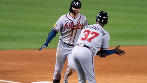 Atlanta Braves' Forrest Wall, left, celebrates with third base coach Ron Washington, right, after hitting a two-run home run during the sixth inning of the second game of a baseball doubleheader against the Washington Nationals, Sunday, Sept. 24, 2023, in Washington. (AP Photo/Stephanie Scarbrough)