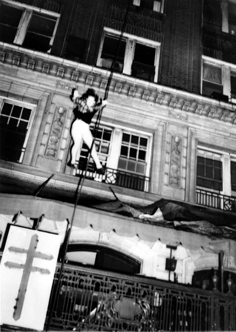 In this Dec. 7, 1946, photo, a woman leaps from an upper story to escape the burning Winecoff Hotel in Atlanta. Seconds later the woman crashed to her death on the hotel marquee. An amateur photographer captured the horror of a woman leaping to escape flames roaring through the Winecoff Hotel in Atlanta. The blaze killed 119 people and led President Truman to call for new fire safety codes nationwide. (AP Photo/Arnold Hardy)
