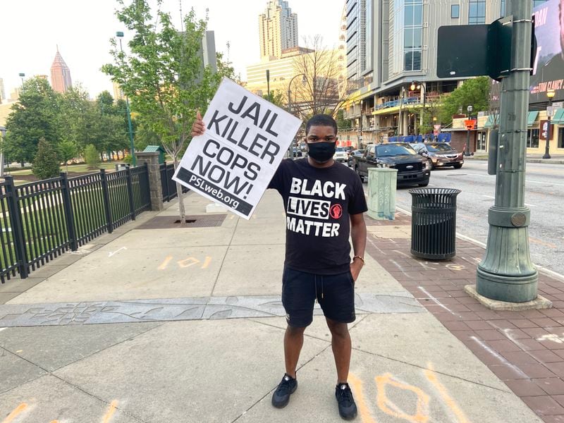 Jerome Trammel, a 31-year-old television producer, arrived at Centennial Olympic Park with a sign that read “Jail Killer Cops Now.”