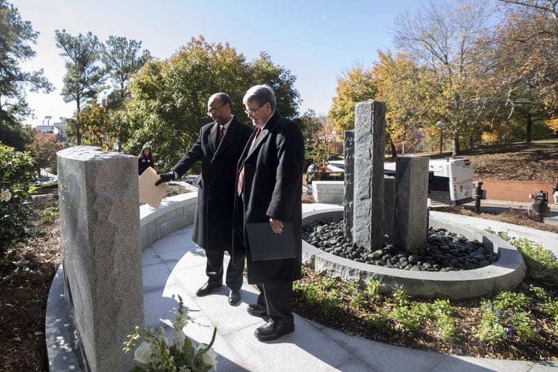 Judge Steve Jones, U.S. District Court Judge for the Northern District of Georgia, and UGA President Jere W. Morehead read the inscription at the Baldwin Hall Memorial Credit: University of Georgia