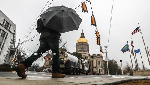 Stormy Thomason strolls along Capitol Avenue during Monday’s drizzle.