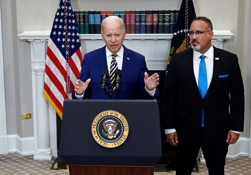 President Joe Biden, with Education Secretary Miguel Cardona at his side, announces student loan relief in August. (Olivier Douliery/AFP via Getty Images/TNS)