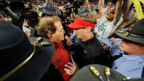 As Alabama begins another celebration inside Mercedes-Benz Stadium, Crimson Tide coach Nick Saban (left) gives his best to Georgia's Kirby Smart.