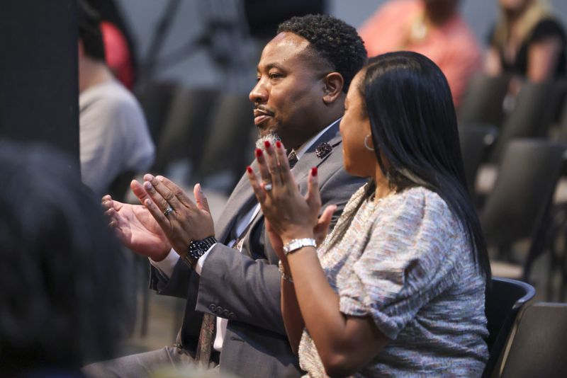 Devon Horton reacts next to his wife Christiane after the DeKalb County Board of Education hired Horton for the superintendent position at the DeKalb County Administrative Center, Wednesday, April 19, 2023, in Stone Mountain, Ga. (Jason Getz / Jason.Getz@ajc.com)