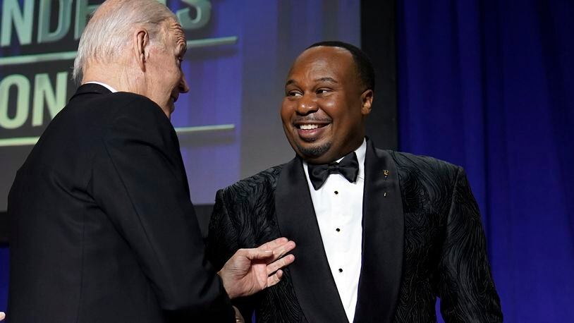 President Joe Biden shakes hands with comedian Roy Wood Jr., a correspondent for "The Daily Show," after he spoke during the White House Correspondents' Association dinner at the Washington Hilton in Washington, Saturday, April 29, 2023. (AP Photo/Carolyn Kaster)