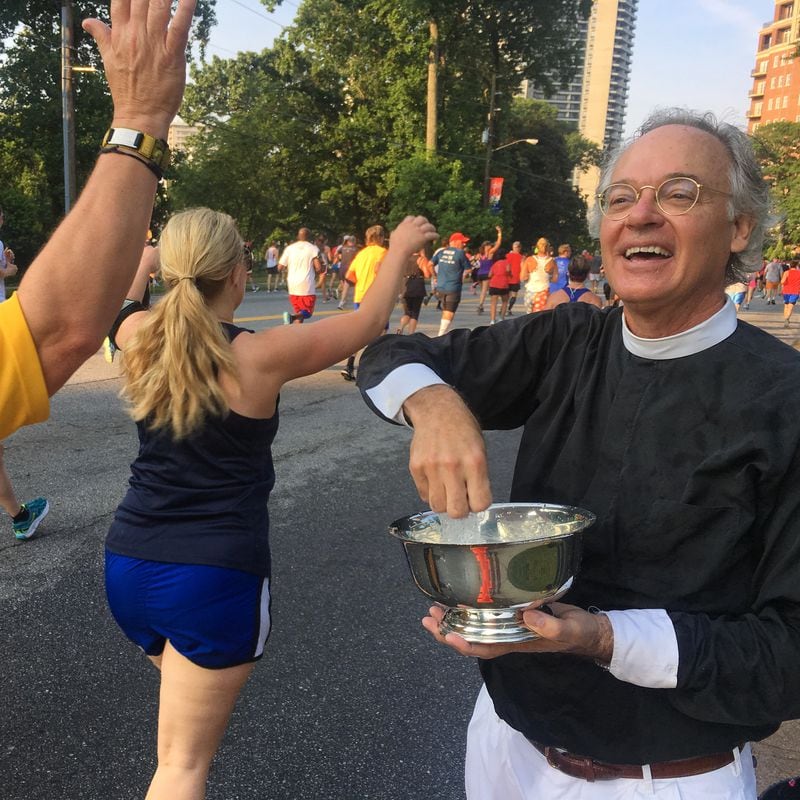 Dean Sam Candler blesses AJC Peachtree Road Race runners on July 4, 2016. AJC photo: Ben Gray / bgray@ajc.com
