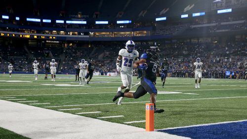 Georgia State Panthers running back Taz Bateman (8) scores a touchdown against Tennessee State Tigers defensive back Vincent Sellers (25) during the second half at Georgia State Stadium Thursday in Atlanta, Ga., August 31, 2017. PHOTO / JASON GETZ