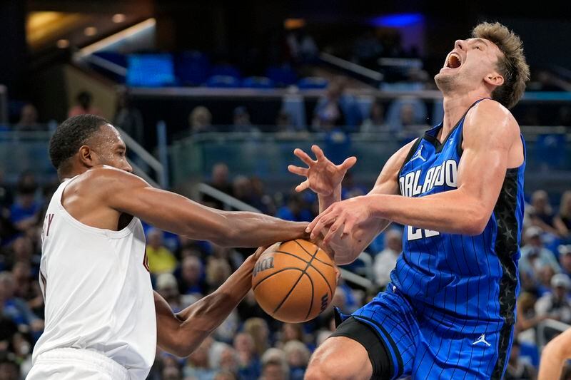 Cleveland Cavaliers forward Evan Mobley, left, fouls Orlando Magic forward Franz Wagner who was going up to shoot during the second half of Game 6 of an NBA basketball first-round playoff series, Friday, May 3, 2024, in Orlando, Fla. (AP Photo/John Raoux)