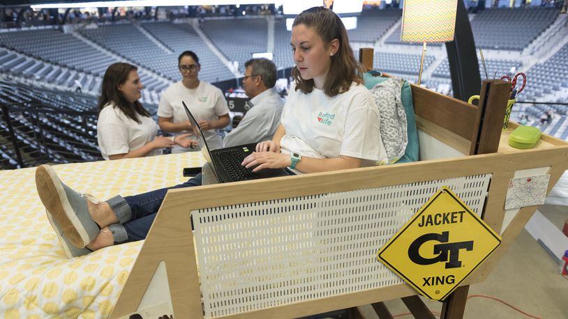 Natalie Larkins, a fourth year industrial design student at Georgia Tech, sits in her group’s demonstration bed during their presentation at the Capstone Expo in Atlanta last week.Two groups of students presented their projects for modified lofts two years after a Georgia Tech student, Clark Jacobs, fell out of his bed. (DAVID BARNES / dbarnes@ajc.com)