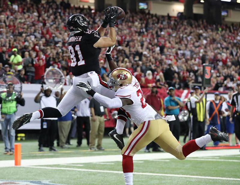 December 18, 2016, ATLANTA: Falcons tight end Austin Cooper catches a touchdown pass over 49ers Jaquiski Tartt for a 21-0 lead during the first quarter in an NFL football game on Sunday, Dec. 18, 2016, in Atlanta. The score set a Falcons single season scoring record. Curtis Compton/ccompton@ajc.com