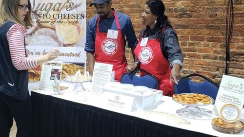 Stacey West (from right) and her son, Quinton Jones of Suga’s Pimento Cheese, talk with a visitor at the reception for finalists in the 2019 Flavor of Georgia competition. CONTRIBUTED BY ROBERT WEST